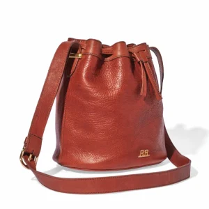 Bucket bag with round base and cylindrical body, drawstring closure with metal grommets, trending fashion-forward silhouette