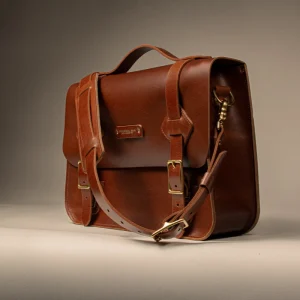 Messenger bag with padded front flap, buckle closure, and long crossbody strap, highest production complexity